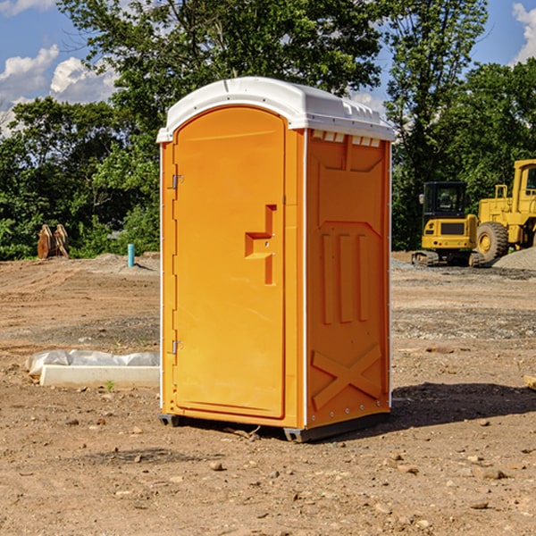 what is the cost difference between standard and deluxe portable restroom rentals in Overgaard